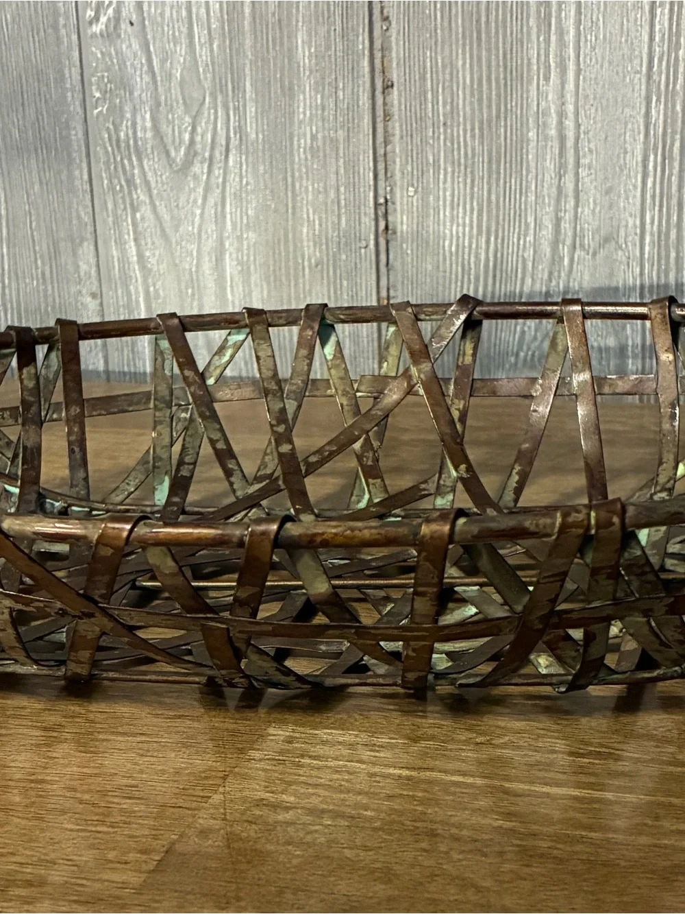 This centerpiece is a vintage woven Rustic Woven Metal Oval Basket